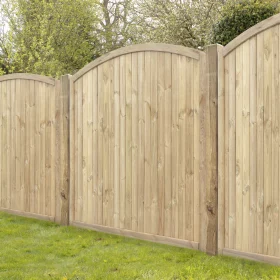 Some tongue and groove arched fence panels put up with posts in a garden