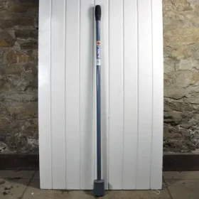 fencing tamper, blue with a black rubber end, in front of a white door.