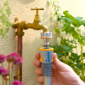 The Hozelock Pro Metal Hose Connector being used to connector to a male metal tap connector