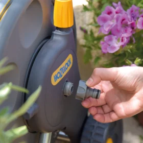 The Hozelock Inlet Adaptor for reels and Carts being connected to a reel for water input