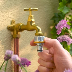 The Hozelock Pro Metal Threaded Tap Connector being used to create a male connection point on a brass outdoor tap