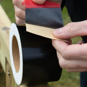 Premium Deck Joist Tape being pulled apart ready to be applied to a timber decking joist