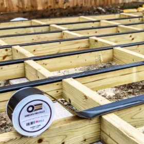 Decking Premium Joist Tape rolled out on some timber joists with some still to tape up