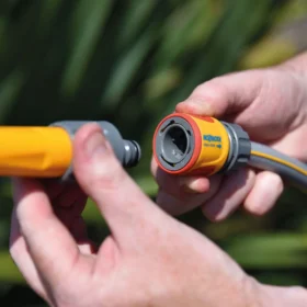 The Hozelock Aquastop Connector being used to connect a hose to a nozzle
