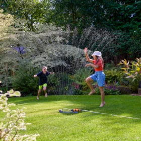 The Hozelock Rectangular Sprinkler 220M being used to spray a garden