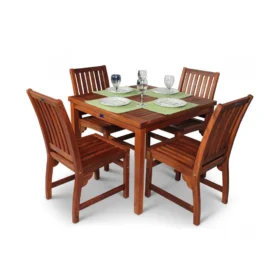 Square wooden dining table set with four matching slatted side chairs, set for four with plates, cutlery, glasses, and green place mats.