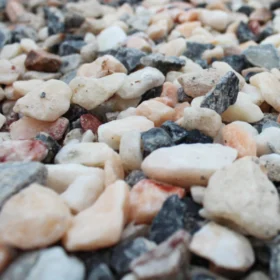 Close-up of flamingo chippings in 20mm size, showing a colourful mix of pink, white, grey and plum decorative stones used for landscaping and driveways.