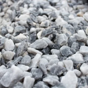 Close-up view of 20mm Polar Blue chippings decorative aggregate, showing a mixture of light and dark grey angular stones with a slightly frosted texture.