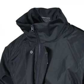 Close-up of navy waterproof jacket showing high collar, full zip closure, and storm flap with snap buttons – designed for maximum rain and wind protection.