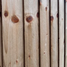 Close-up of closeboard fence panels showing overlapping vertical timber boards, uniform thickness and pressure treated finish for strength and durability.