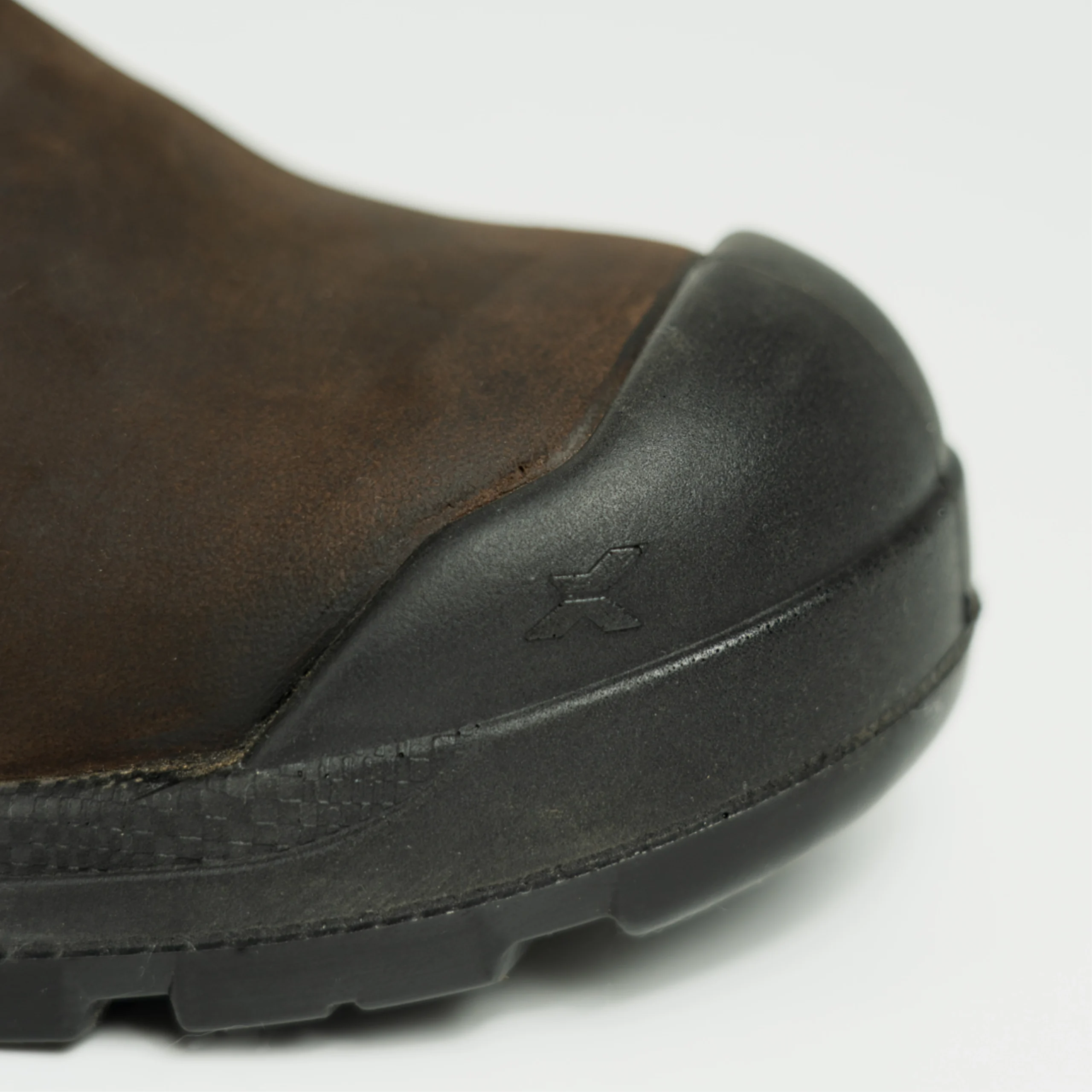 Close-up of Pro Hutton safety boots showing the reinforced black toe cap and durable brown leather upper.