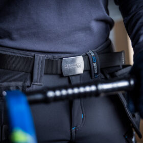 a work belt being used on a pair of work trouser with a blue shirt tucked in
