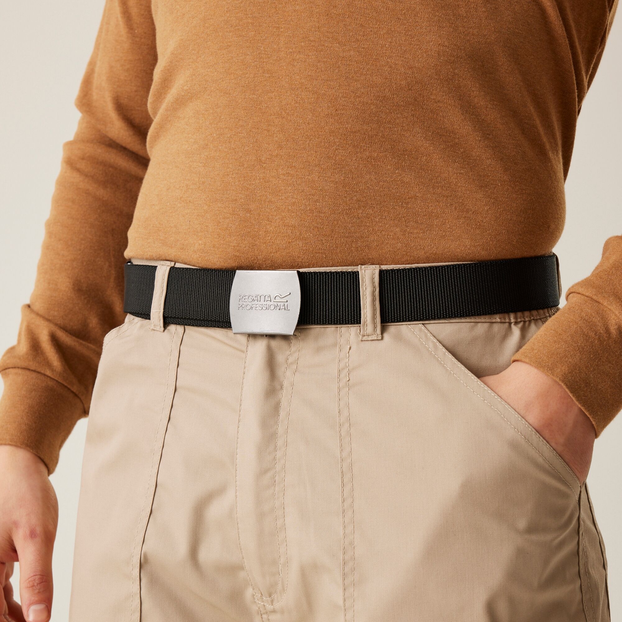 work belt holding up a pair of beige trousers with an orange top above